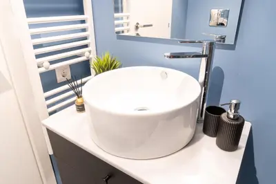 a bathroom with a white sink on a counter at Syntagma Sweet House 2 in Athens