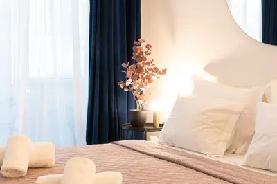a bedroom with a bed with white pillows at Syntagma Sweet House 2 in Athens