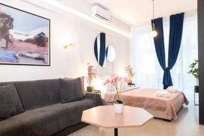 a living room with a couch and a bed at Syntagma Sweet House 3 in Athens