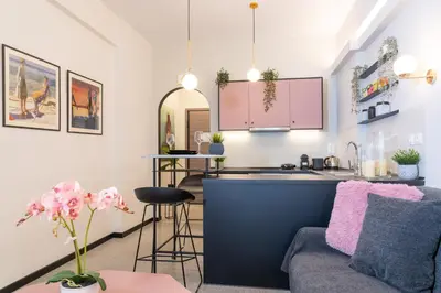 a living room with a couch and a kitchen at Syntagma Sweet House 3 in Athens