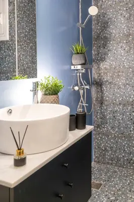 a bathroom with a white sink and a shower at Syntagma Sweet House 3 in Athens