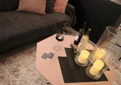 a table with two glasses of wine and candles on it at Syntagma Sweet House 4 in Athens