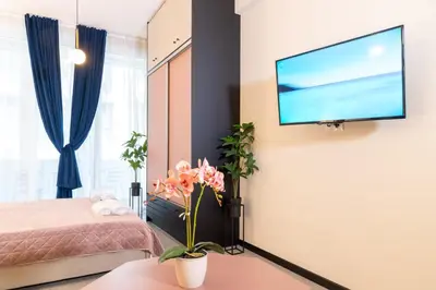 a bedroom with a bed and a flat screen tv on a wall at Syntagma Sweet House 4 in Athens