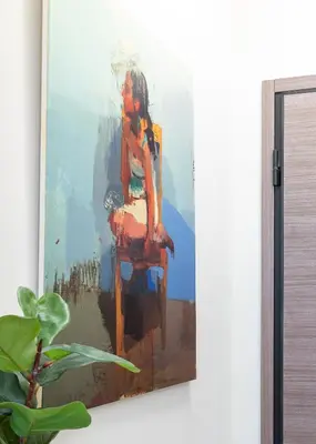 a painting of a woman sitting on a chair at Syntagma Sweet House 4 in Athens
