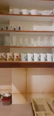 a shelf with cups and saucers on it at Glyfada-Elliniko in Athens