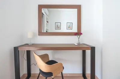 a dressing table with a mirror and a chair at Noho apartments x Koukaki dikaiou 6 in Athens