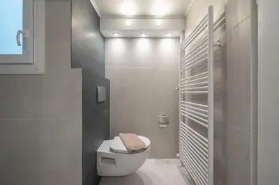 a bathroom with a white toilet in a room at Noho apartments x Koukaki dikaiou 6 in Athens