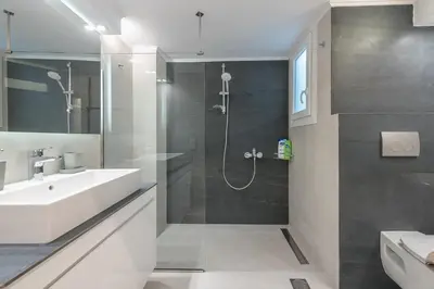 a bathroom with a white sink and a shower at Noho apartments x Koukaki dikaiou 6 in Athens