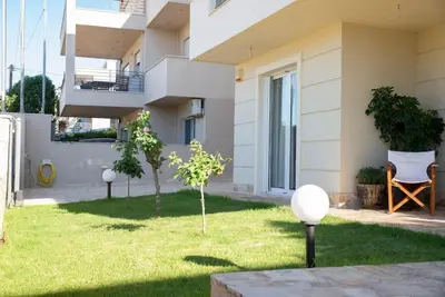 a garden in front of a building at Vasiliki's House in Porto Rafti