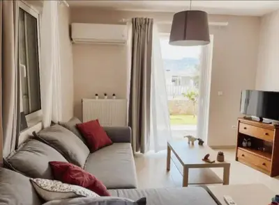 a living room with a couch and a table at Vasiliki's House in Porto Rafti