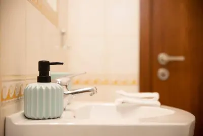 a soap dispenser sitting on top of a bathroom sink at Vasiliki's House in Porto Rafti