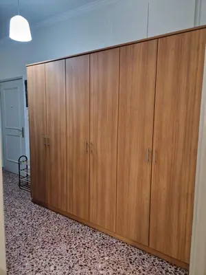 a large wooden cabinet in a room at EstellApartments in Athens