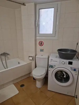 a bathroom with a toilet and a washing machine at EstellApartments in Athens