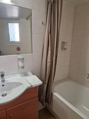 a bathroom with a sink and a bath tub at EstellApartments in Athens