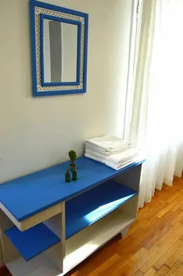 a blue desk with a mirror in a room at EstellApartments in Athens