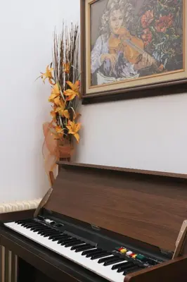 a piano in a room with a painting on the wall at Secret Garden Home Lagonissi Attiki in Foinikiá