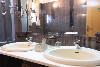 a bathroom with two sinks and a large mirror at Secret Garden Home Lagonissi Attiki in Foinikiá