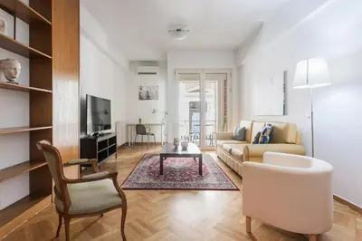a living room with a couch and a table at Neat Kolonaki Apartment, Athens City Centre - NV8 in Athens