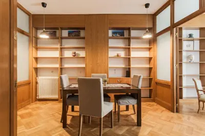 a dining room with a table and chairs and shelves at Neat Kolonaki Apartment, Athens City Centre - NV8 in Athens