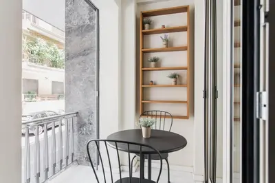 a small black table and chairs on a balcony at Neat Kolonaki Apartment, Athens City Centre - NV8 in Athens