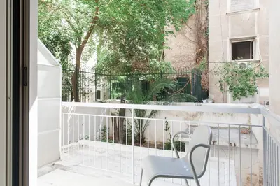 a balcony with a chair and a table at Neat Kolonaki Apartment, Athens City Centre - NV8 in Athens