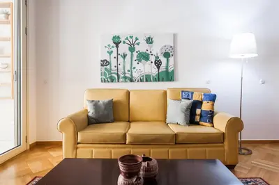 a living room with a couch and a table at Neat Kolonaki Apartment, Athens City Centre - NV8 in Athens
