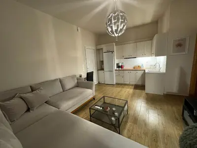 a living room with a couch and a table at Serenity - Brand New Apt Near Athens Int Arpt in Spáta
