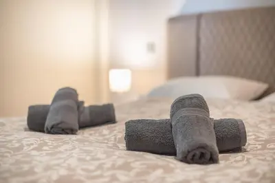 a pair of rolled up towels on a bed at Panathenaic Stadium By Greece Apartments in Athens