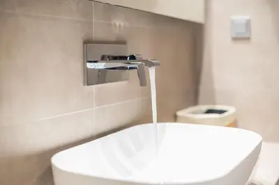 a bathroom with a sink and a toilet at Panathenaic Stadium By Greece Apartments in Athens