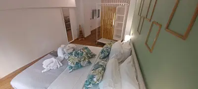 a bed with two pillows on it in a room at The Owl nest Modern and Cozy place in the Historical Center in Athens