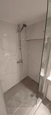 a bathroom with a shower with a glass door at The Owl nest Modern and Cozy place in the Historical Center in Athens