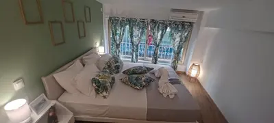 a bedroom with a bed with pillows and a window at The Owl nest Modern and Cozy place in the Historical Center in Athens