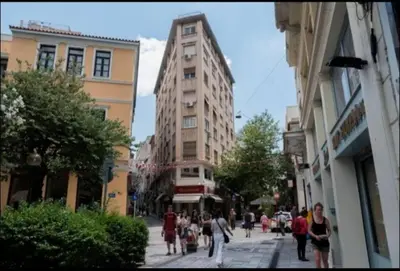 a group of people walking down a city street at The Owl nest Modern and Cozy place in the Historical Center in Athens