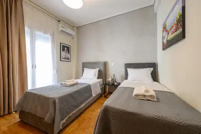 two beds sitting next to each other in a bedroom at Athens city spot in Athens