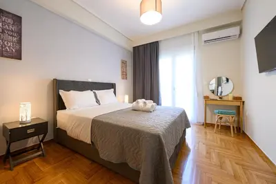 a bedroom with a bed with a teddy bear on it at Athens city spot in Athens