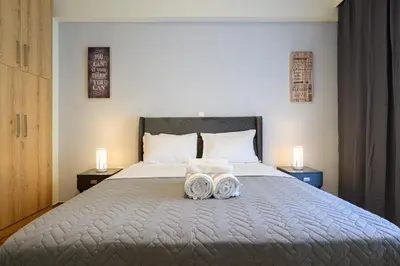 a bedroom with a bed with two towels on it at Athens city spot in Athens