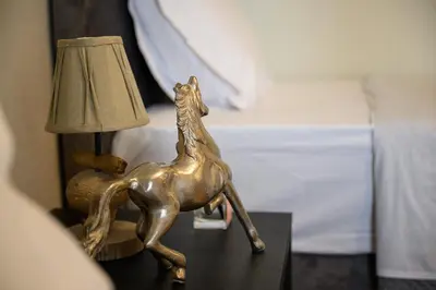 a bronze statue of a horse on a table next to a bed at Athens city spot in Athens