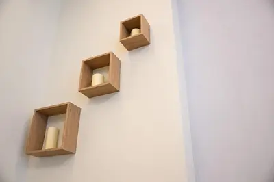 a wall with three wooden shelves on a wall at Athens city spot in Athens