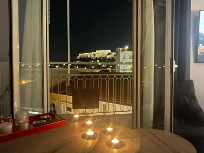 a room with a balcony with candles on the floor at Apartment 55 in Athens