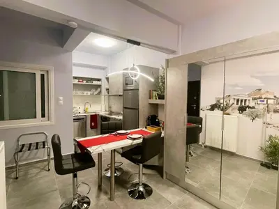 a kitchen with a table and chairs in a room at Apartment 55 in Athens