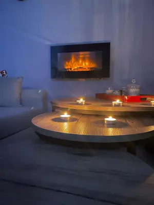 a living room with a coffee table in front of a fireplace at Apartment 55 in Athens