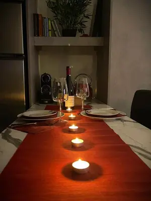 a wooden table with candles and wine glasses on it at Apartment 55 in Athens