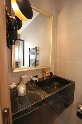 a bathroom with a sink and a mirror at IPELHOME-Avissinias Boutique Apartments in Athens