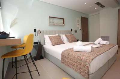 a bedroom with a bed with towels on it at IPELHOME-Avissinias Boutique Apartments in Athens