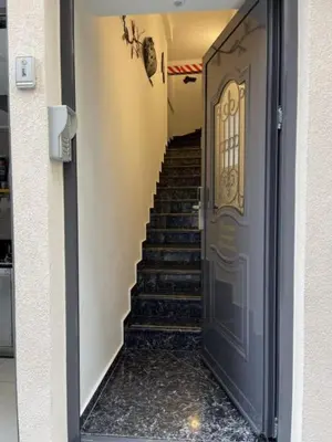 a stairway with a blue door and stairs in a building at IPELHOME-Avissinias Boutique Apartments in Athens