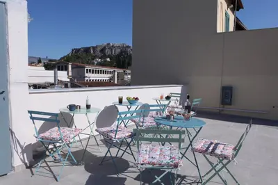 a table and chairs on a patio with a view at IPELHOME-Avissinias Boutique Apartments in Athens