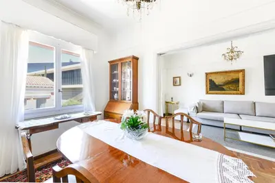 a living room with a table and a couch at Athenean Classic Apartment at Acropolis Museum & Metro in Athens