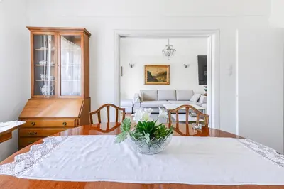 a living room with a table and a couch at Athenean Classic Apartment at Acropolis Museum & Metro in Athens
