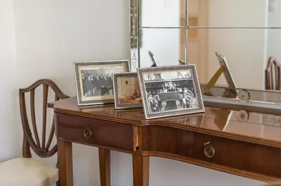 a table with three pictures on it with a mirror at Athenean Classic Apartment at Acropolis Museum & Metro in Athens