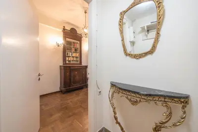 a hallway with a mirror and a console table at Athenean Classic Apartment at Acropolis Museum & Metro in Athens